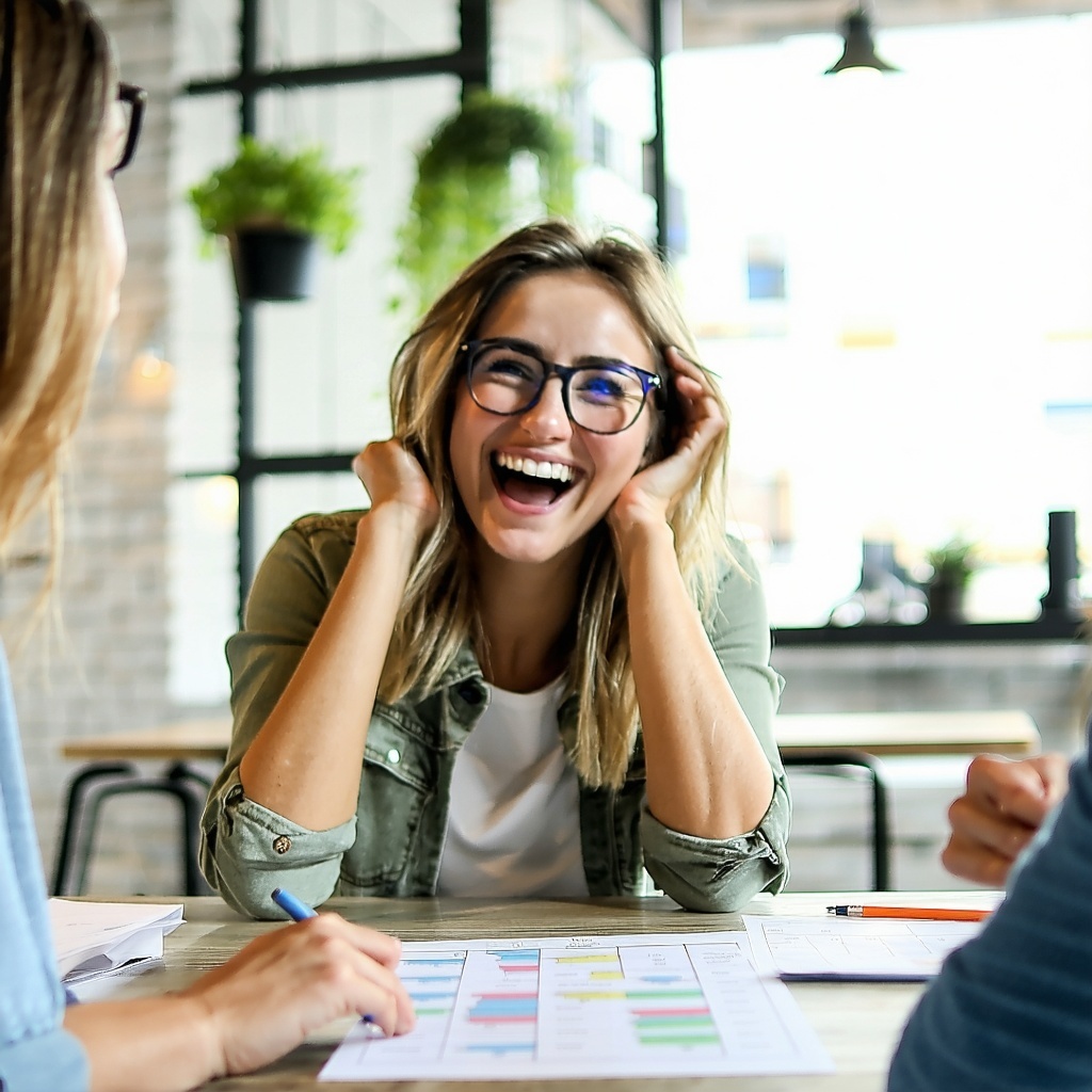 An image of a happy woman trying to make a decision at a table-1